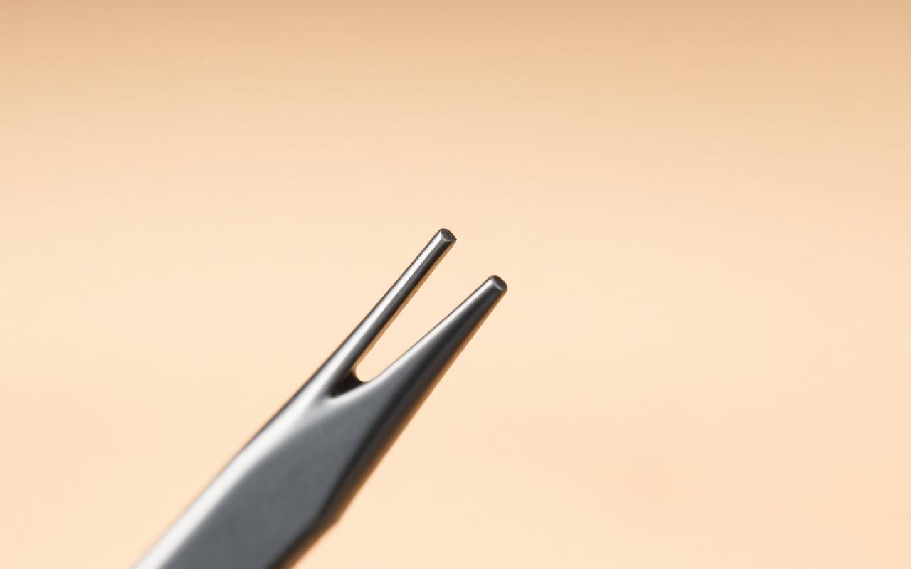Close-up of precision tweezer jaws meeting flush along the full edge